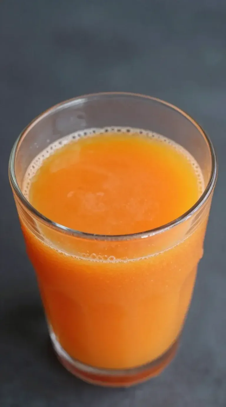 Top view glass of carrot ginger orange juice, condensation